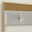 Close-up of Volare bed headboard featuring premium fabric and elegant wood accent in a minimalist design.