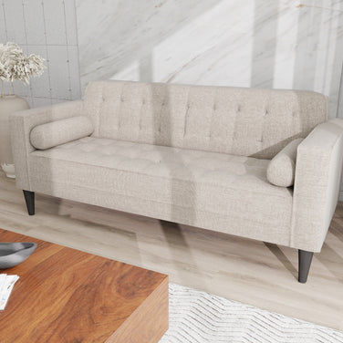 Arcadia grey 3-seater fabric sofa with tufted back and seat, bolster cushions, and dark tapered legs.
