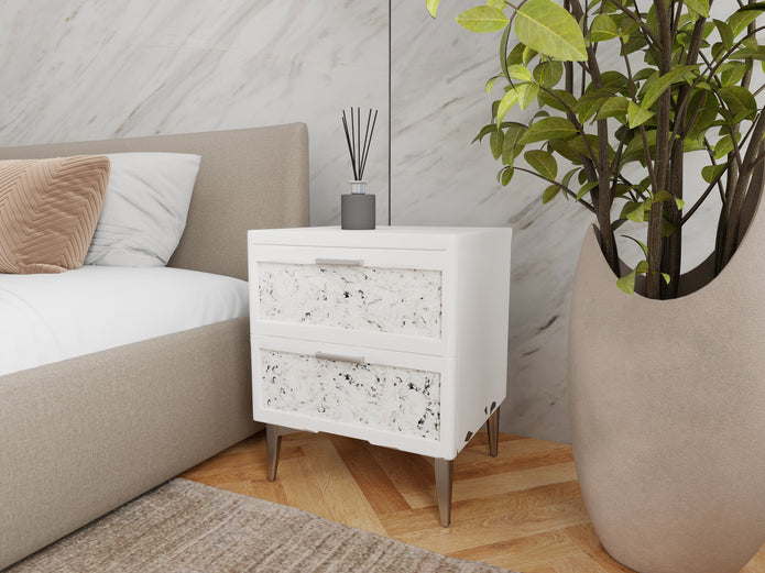 Slate nightstand styled next to an upholstered bed in a modern bedroom